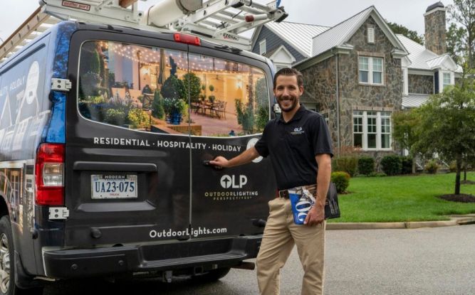 Outdoor Lighting Perspectives Franchise Employee with Truck in front of a light job