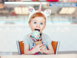 A girl with a unicorn headband and an ice cream