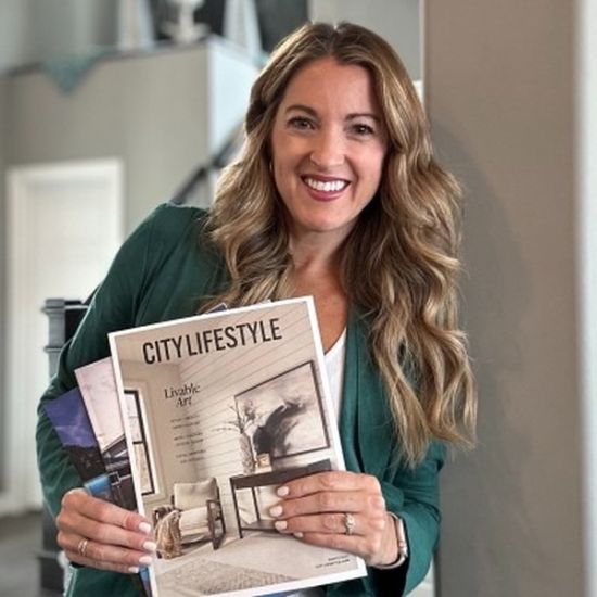 Woman holding a City Lifestyle magazine, showcasing the cover design