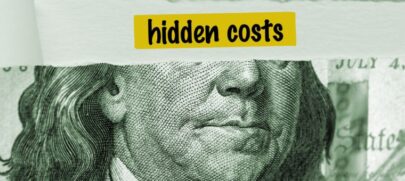 A U.S. one-hundred-dollar bill with a white strip covering the eyes of Benjamin Franklin’s portrait, with the word “Hidden Costs” to depict Hidden Franchise Fees.