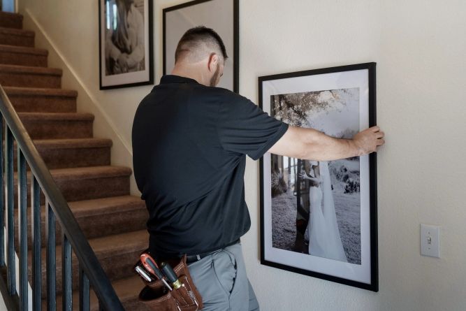 Monty's Handyman hanging a picture 